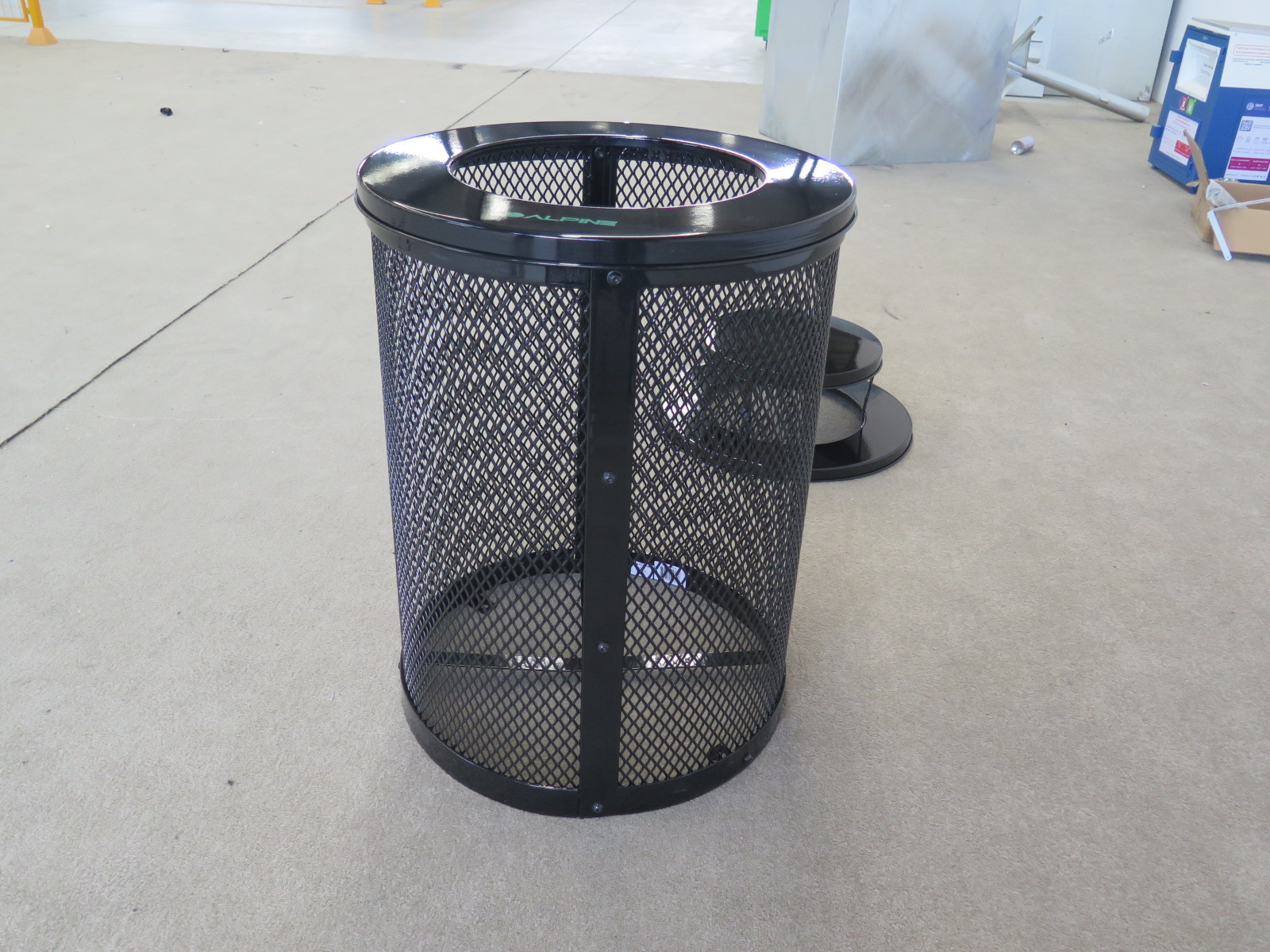 Commercial-grade outdoor trash can for urban sidewalk and facility waste management.
